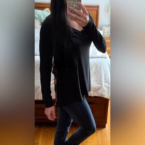 Black sweater with floral detail.